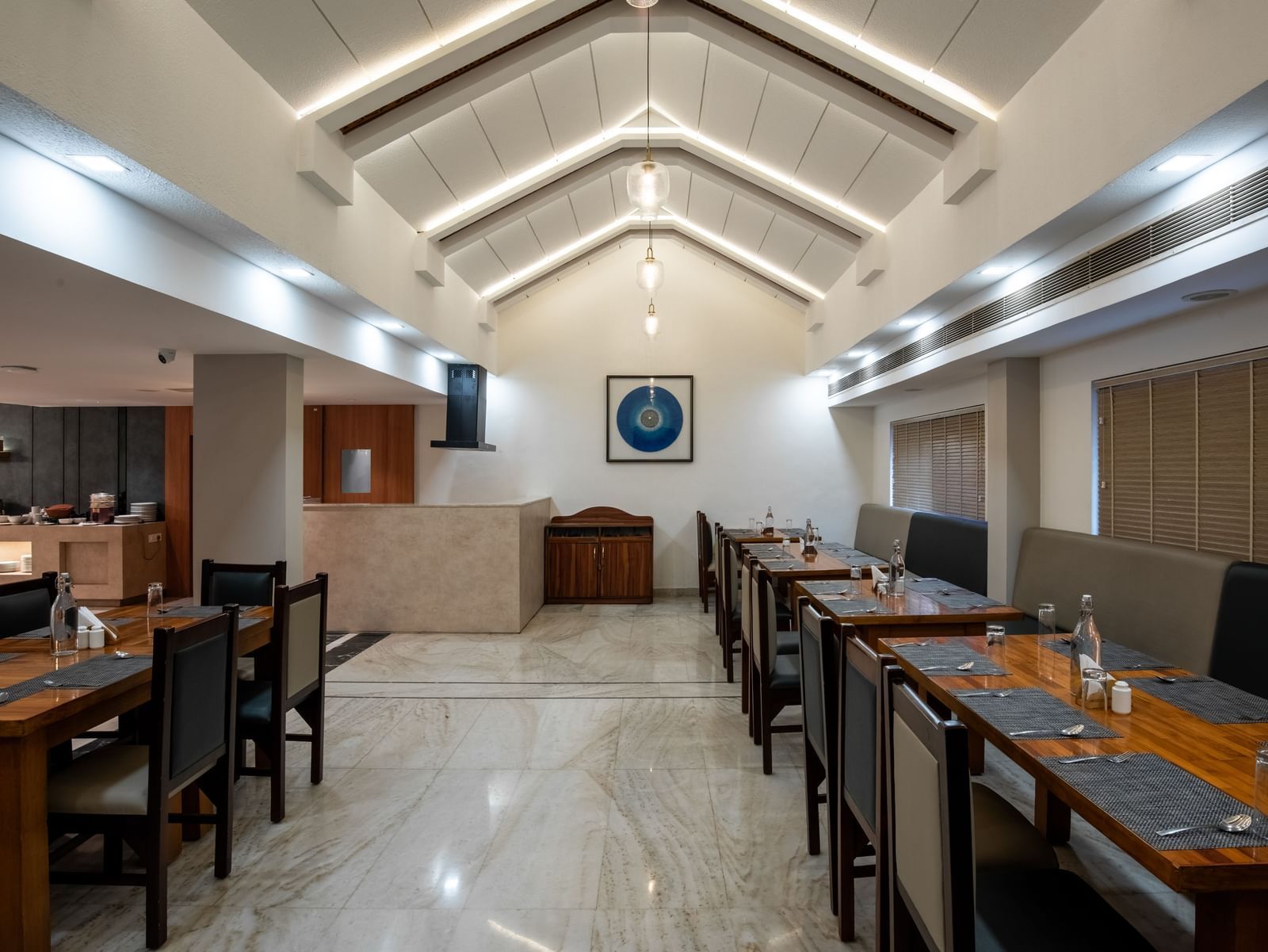 Well-lit restaurant with contemporary seating arrangement at Hotel Royal Regency Chennai