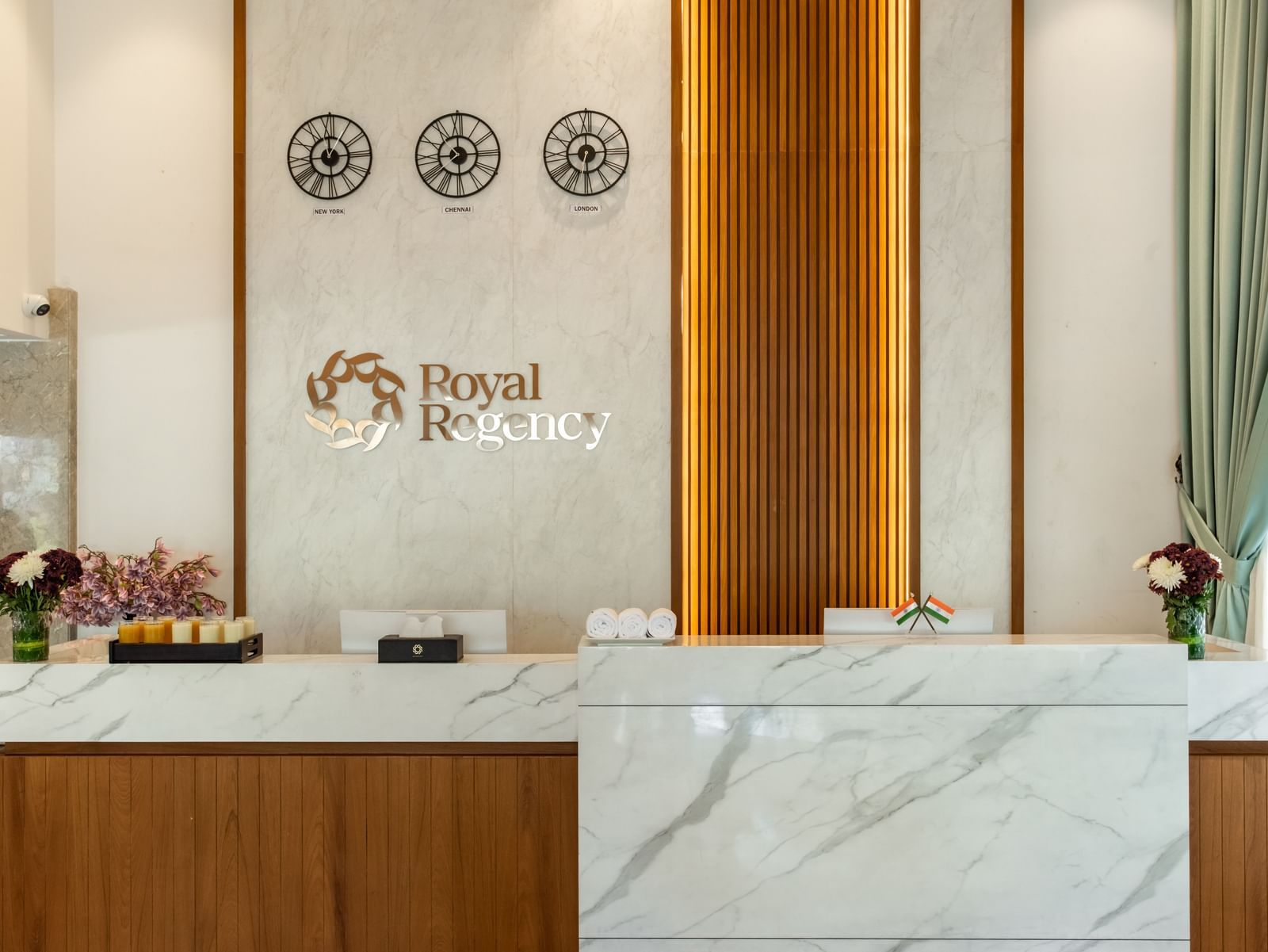 Reception desk with Royal Regency branding and decor at Hotel Royal Regency Chennai