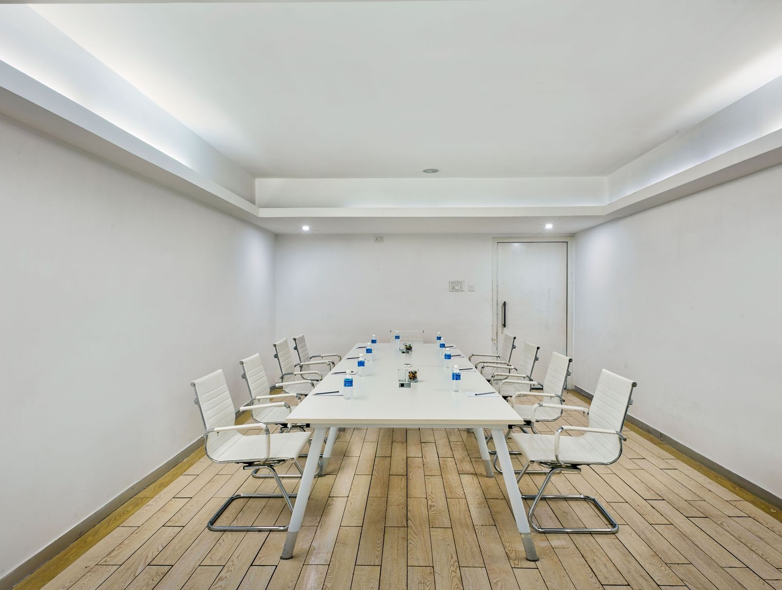Conference room with long white table and white chairs at Grande Bay Resort & Spa.