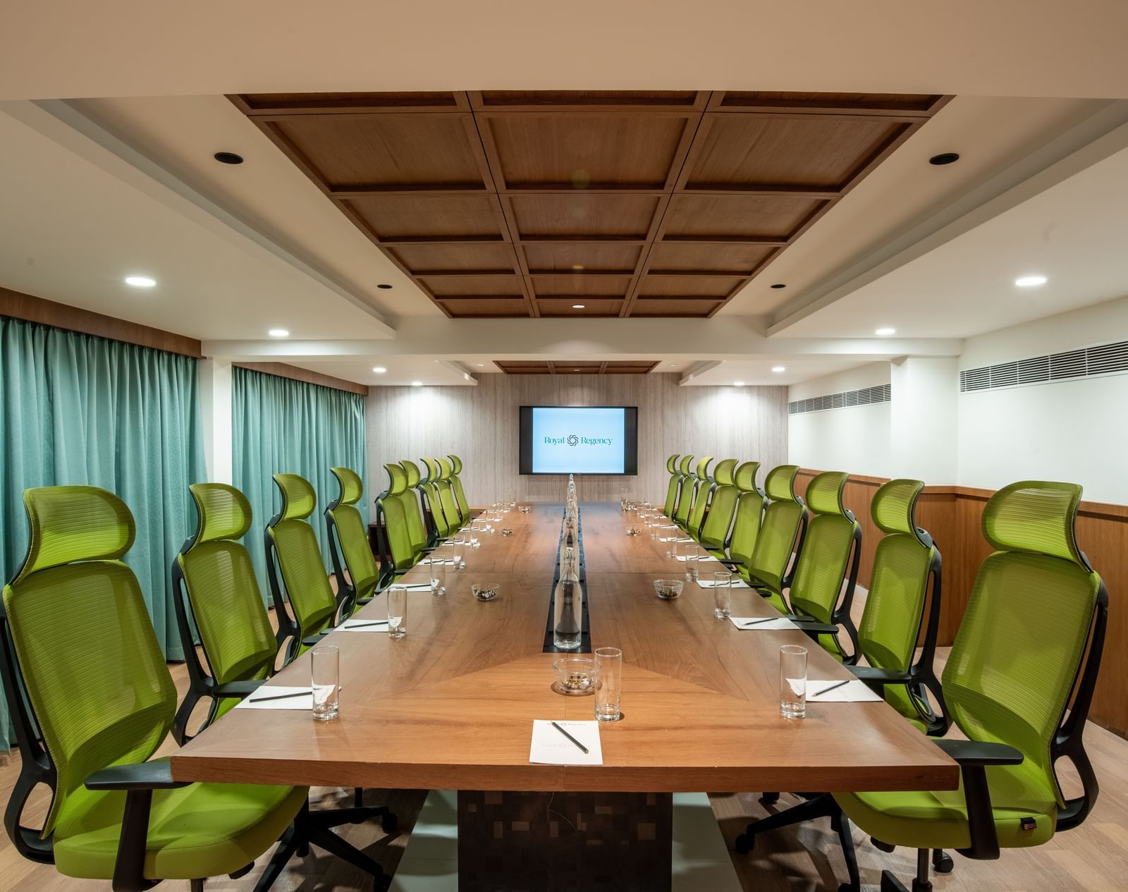 Professional meeting room with presentation screen and chairs at Hotel Royal Regency Chennai