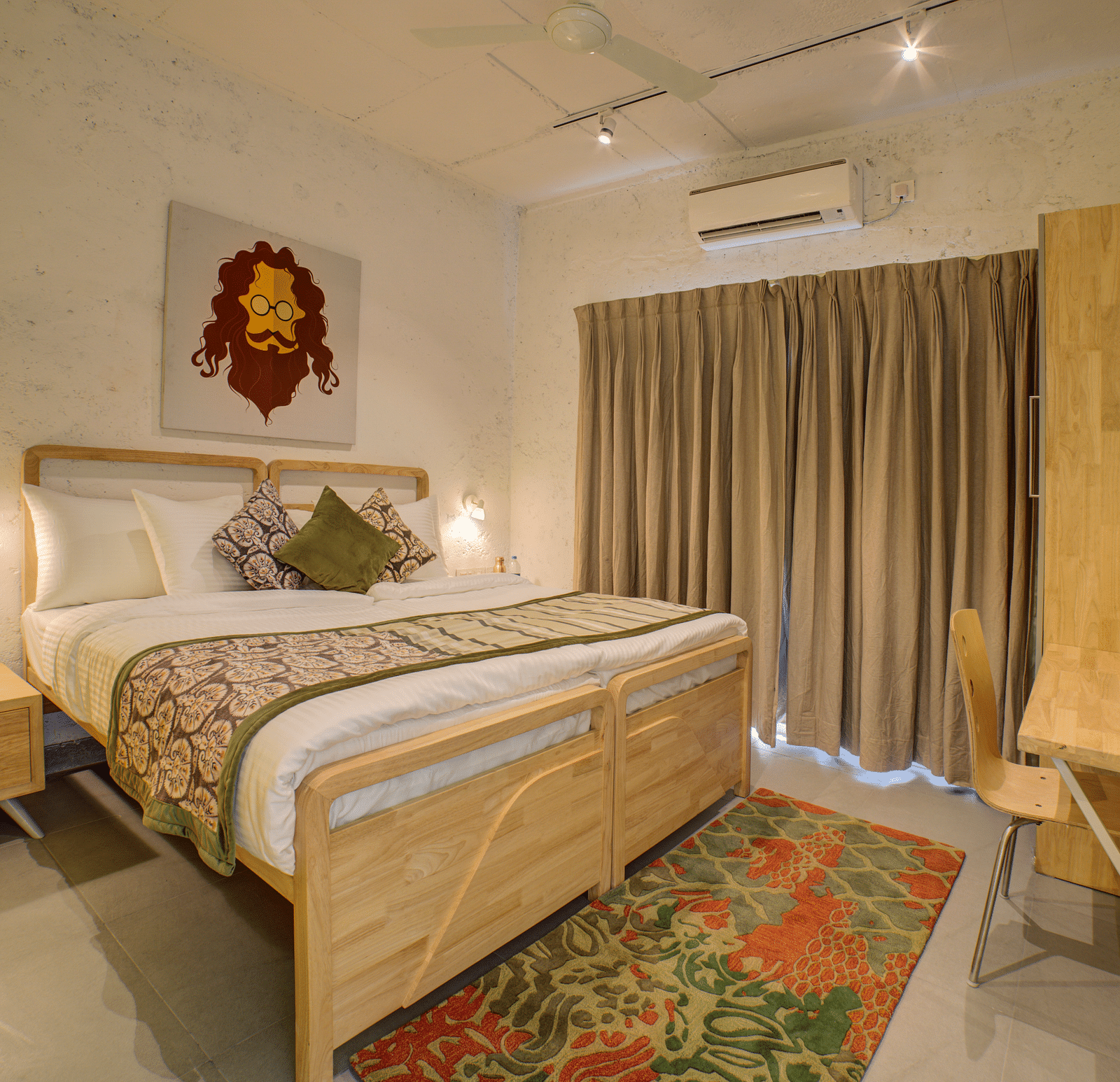 A large bedroom with a large bed with two side drawer and side lamps facing a television - Bedzzz, Rishikesh