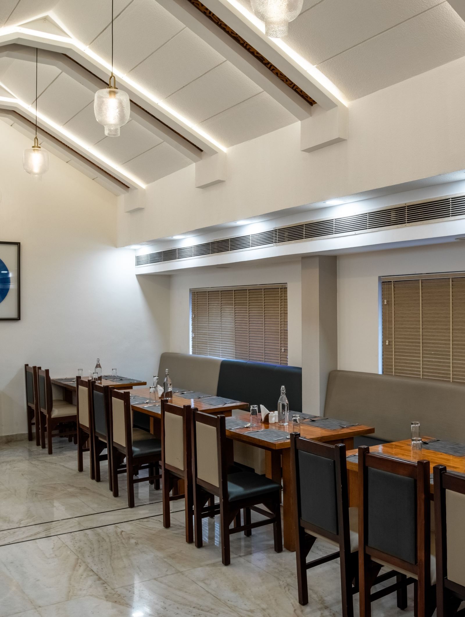 Restaurant dining area with neatly arranged tables and chairs at Hotel Royal Regency Chennai