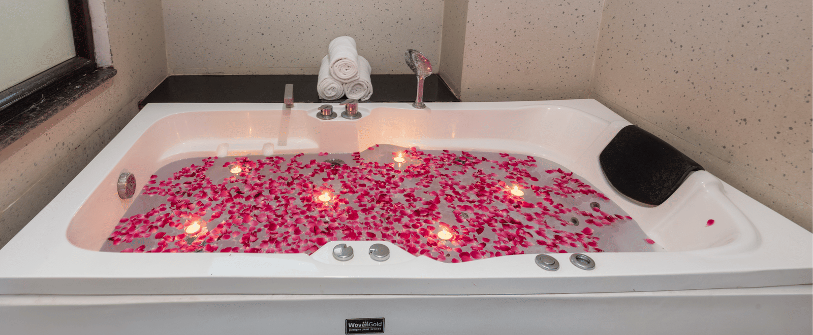 Bathtub decorated with rose petals at DLS Hotels On The Ganges.