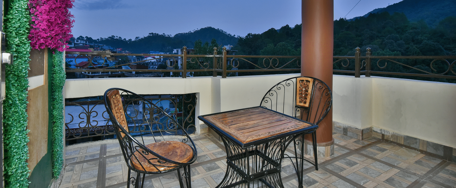 Balcony of a Super Deluxe Room at DLS Dalhousie Valley Resort with chairs and table