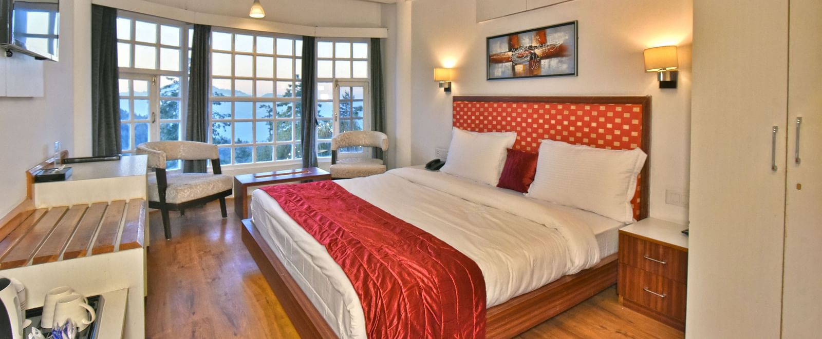 Bedroom with a fancy ceiling and warm illuminating lights at DLS Hillcrest Resort, Shimla.