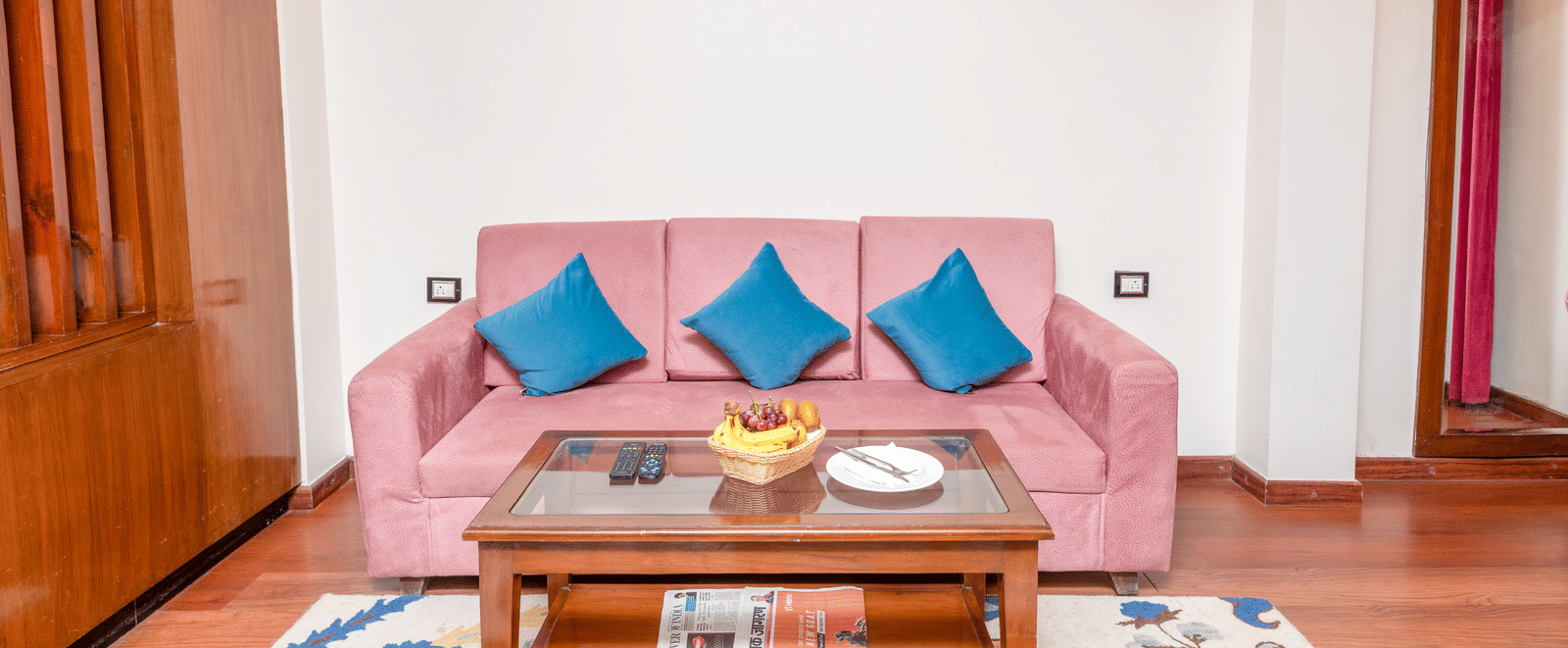 Cozy living room with pink sofa at DLS Hotels On The Ganges.