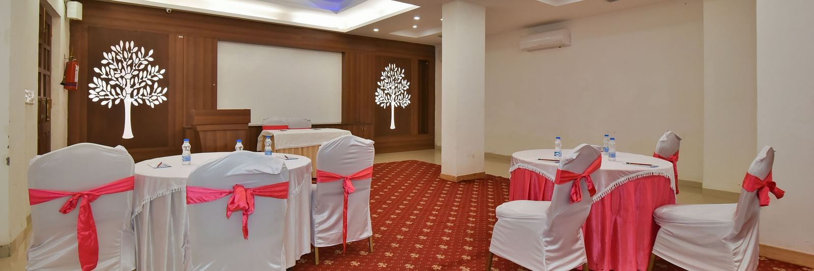 A conference hall with comfortable chairs facing the podium at DLS Highland Resort and Spa, Mussoorie.