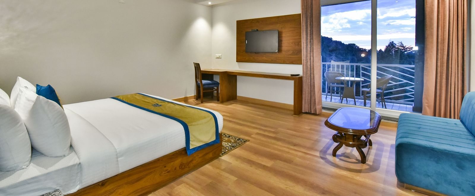 A view of the TV placed in front of the TV in Premium Room With Balcony at DLS Ark Holiday Inn, Banikhet.