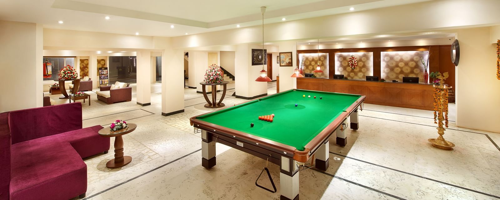 Lobby area of Accord Highland Ooty with a snooker table placed in front of the reception desk