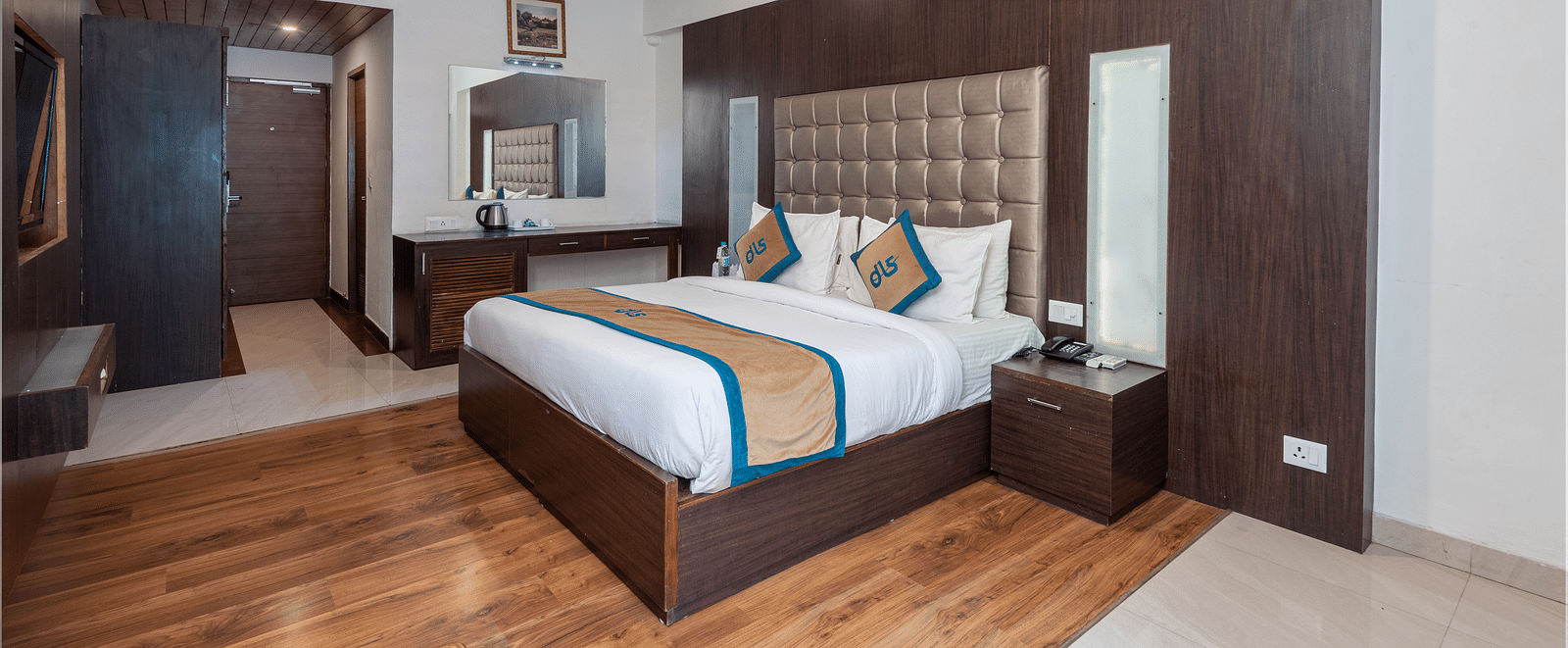 Overview of Premium Room at DLS Spring Valley Resort Dharamshala featuring a king size bed, TV and a chair