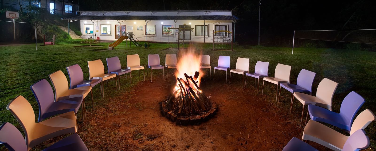 A bonfire arrangement in the lawn at Accord Highland Ooty at night