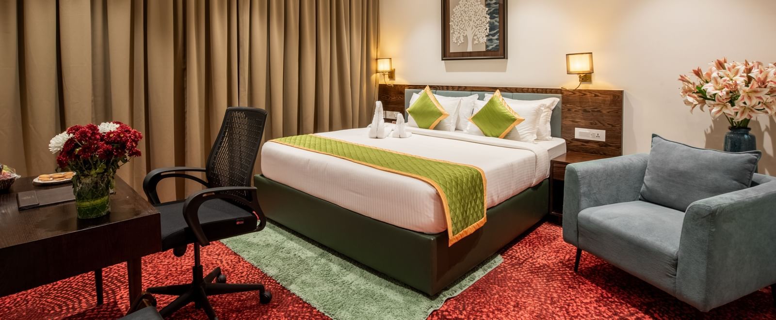 Elegant room with king size bed, seating area, and modern decor at Hotel Royal Regency Chennai