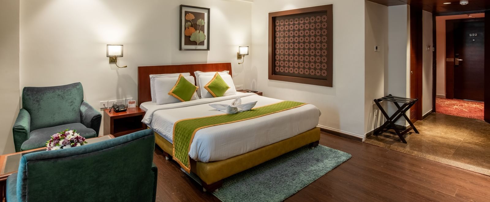 Room with modern decor, seating space, and wooden flooring at Hotel Royal Regency Chennai