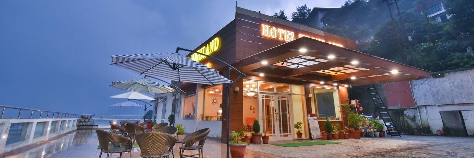 View of DLS Highland Resort and Spa, Mussoorie with comfortable seating area at the front. 