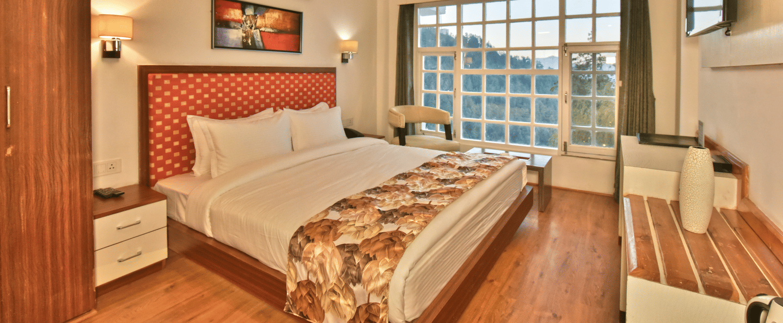 Bedroom with a wooden wardrobe next to it at DLS Hillcrest Resort, the best place to stay near Shimla.