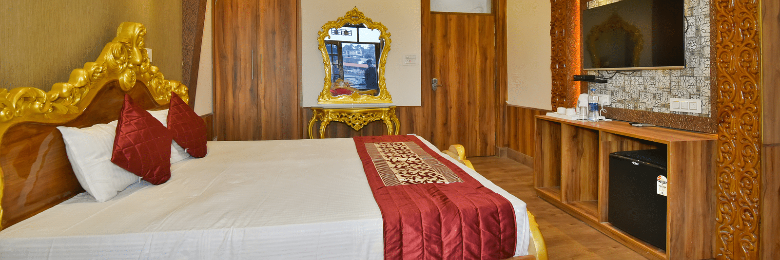Super Deluxe Room at DLS Dalhousie Valley Resort with a  king size bed, a TV and ambient lighting 