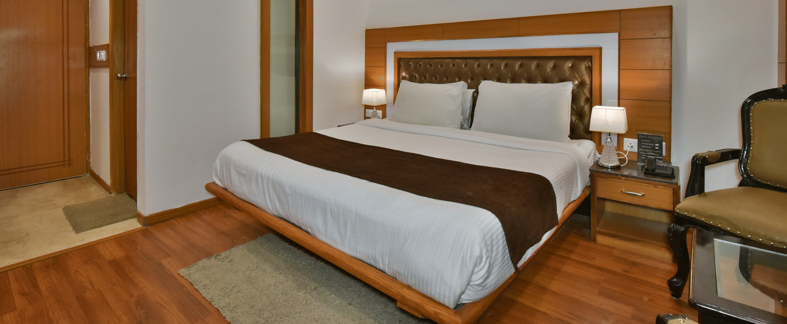 A large bed in Luxury Room Without Balcony at DLS Highland Resort and Spa, Mussoorie, with elegant flooring and modern interiors.