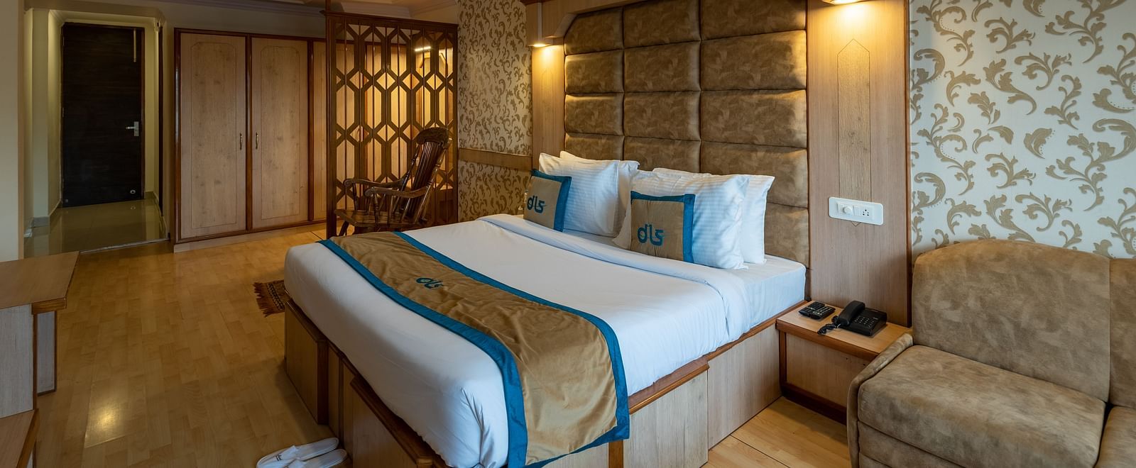 A premium room with a comfortable bed, wooden decor, cosy seating, a wardrobe, and modern amenities for a relaxing stay - DLS Meghavan Resort, Dharamshala