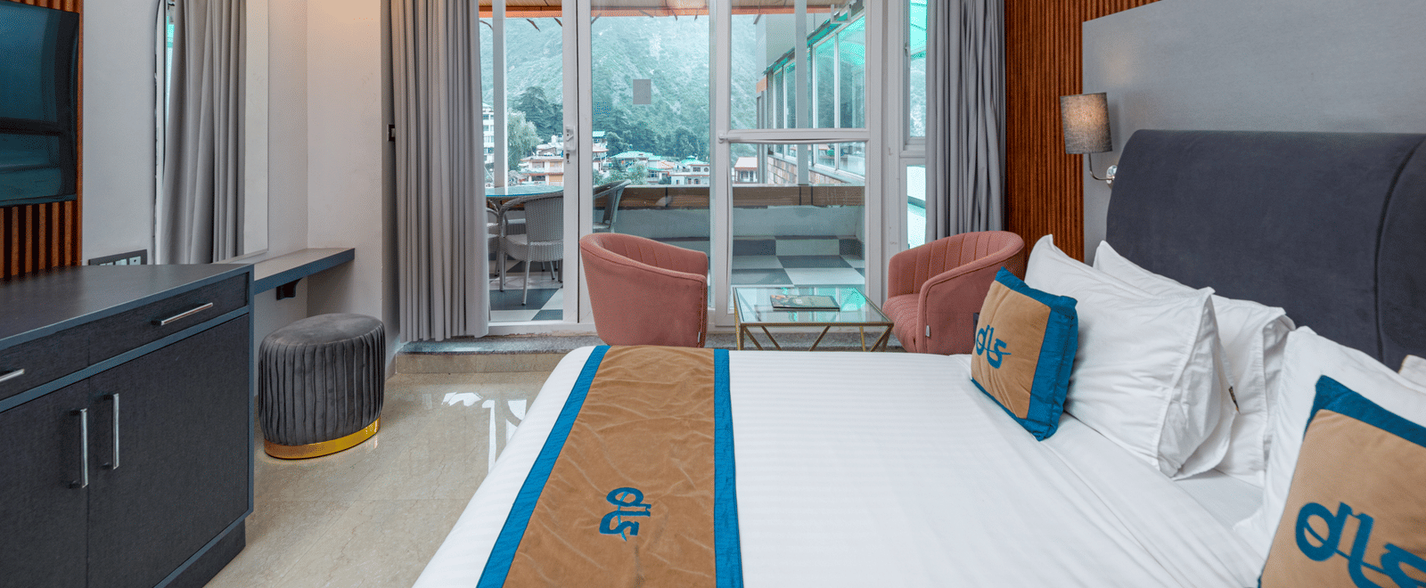 Spring Duplex Room at DLS Spring Valley resort Dharamshala featuring a king bed table, chairs and a balcony