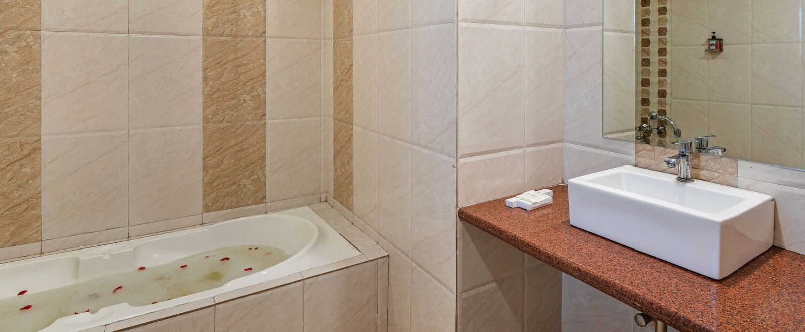 Modern tiled bathroom at Emerald Retreat, Tungarli with a built-in bathtub and sleek vanity unit.