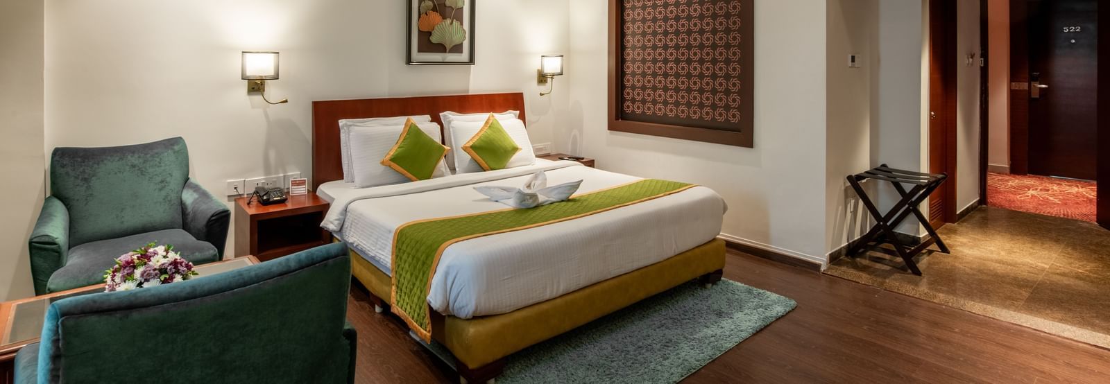 Room with modern decor, seating space, and wooden flooring at Hotel Royal Regency Chennai