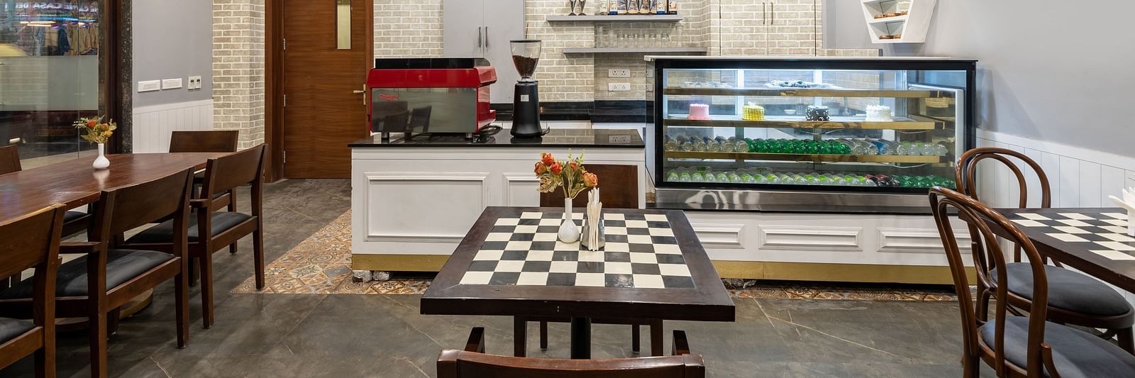Interior view of the cafe with tables and chairs at DLS The Classio, Rishikesh