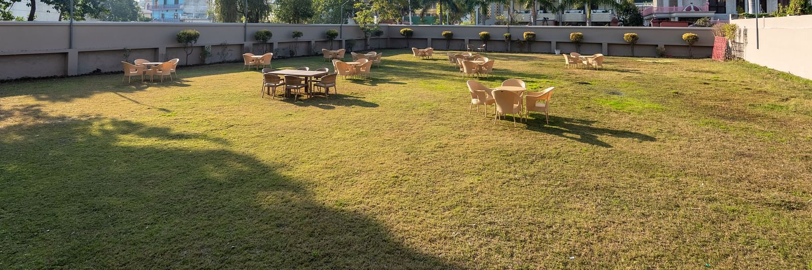 Spacious lawn area with seating arrangements at DLS Park Grace, Haridwar.