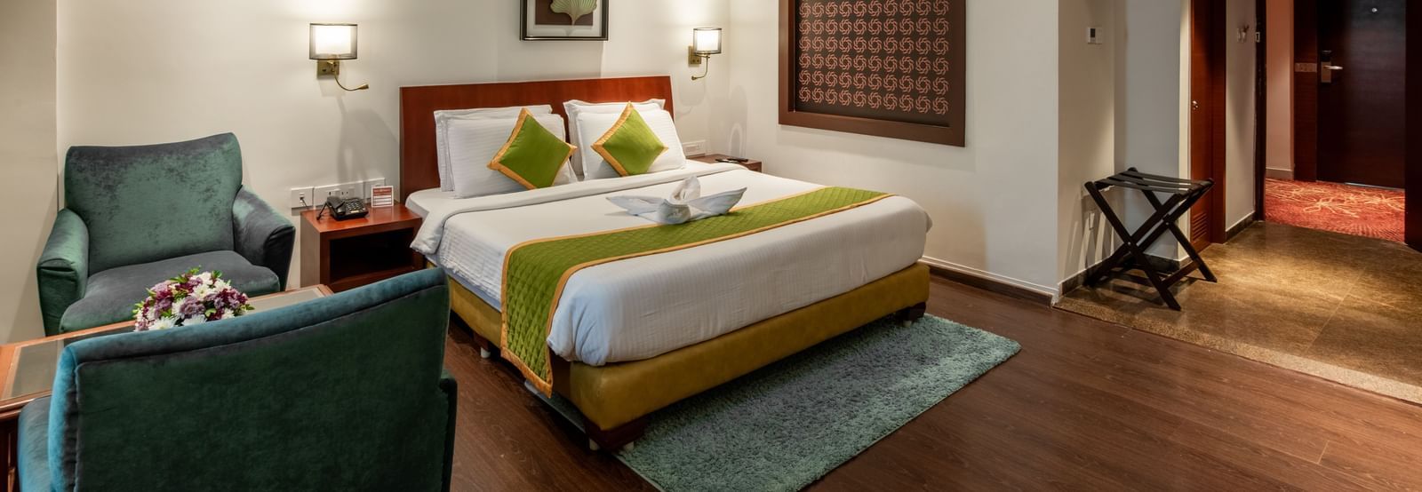 Room with modern decor, seating space, and wooden flooring at Hotel Royal Regency Chennai