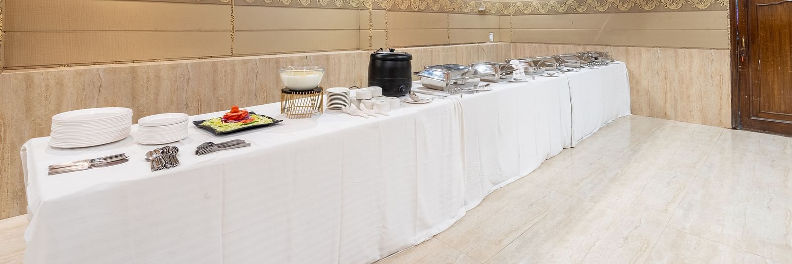 Buffet set up in the banquet hall with cutlery at DLS Park Grace, Haridwar.