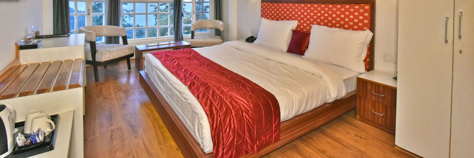 Bedroom with a fancy ceiling and warm illuminating lights at DLS Hillcrest Resort, Shimla.