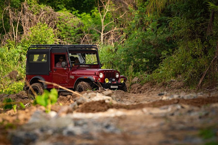 a Jeep travelling by the river bed near Ibex River Resort, Pollachi