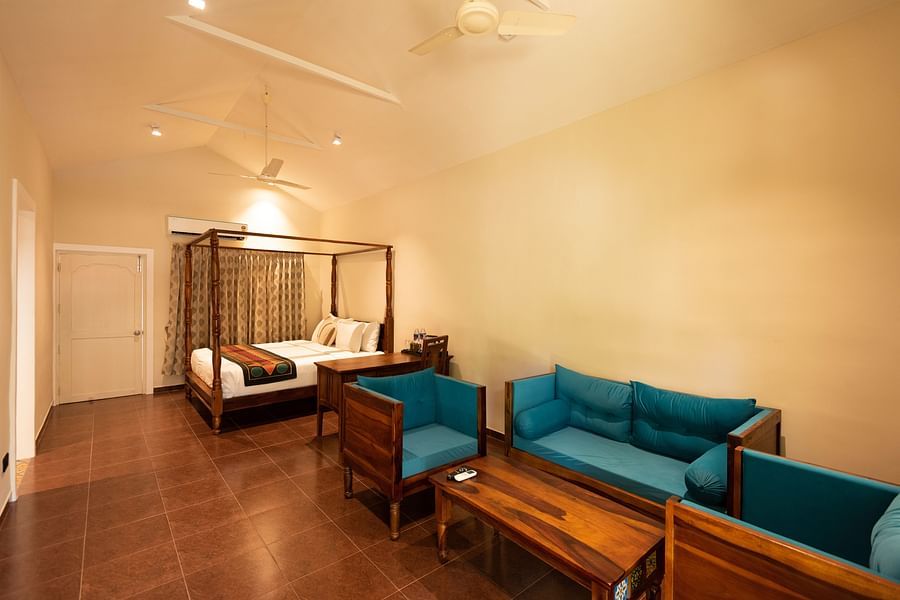 another view of sofas and a double bed inside Suite Room at Ibex River Resort, Pollachi