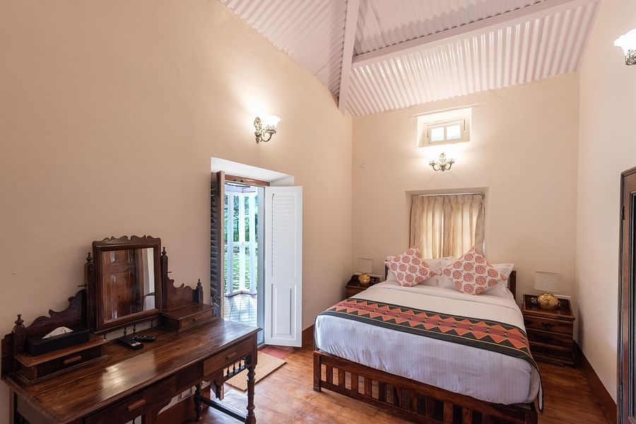 The interiors of Strand bedroom with a plush double bed and other amenities - Ibex Stays & Trails, Coonoor (Leewood).