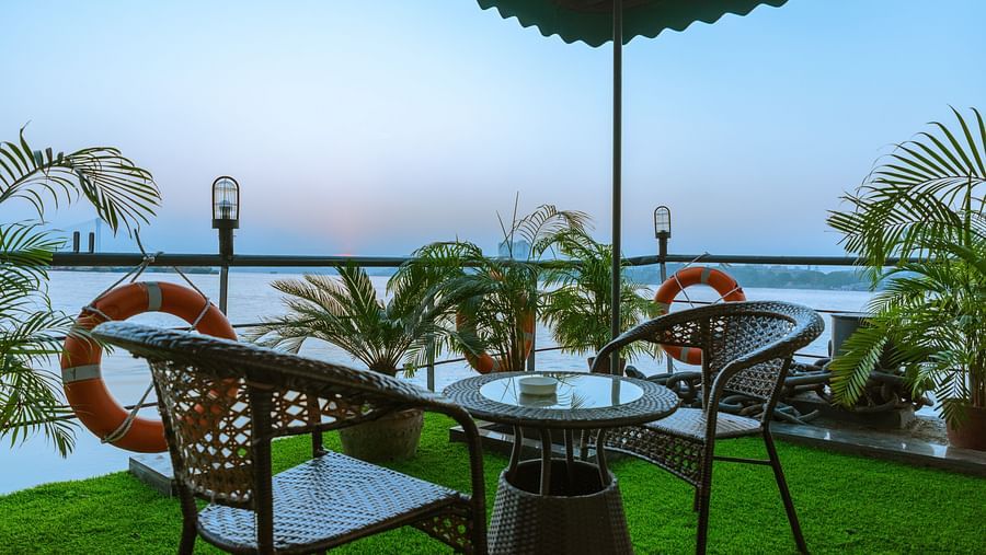 a seat for two on the outside deck overlooking river hooghly - polo floatel kolkata