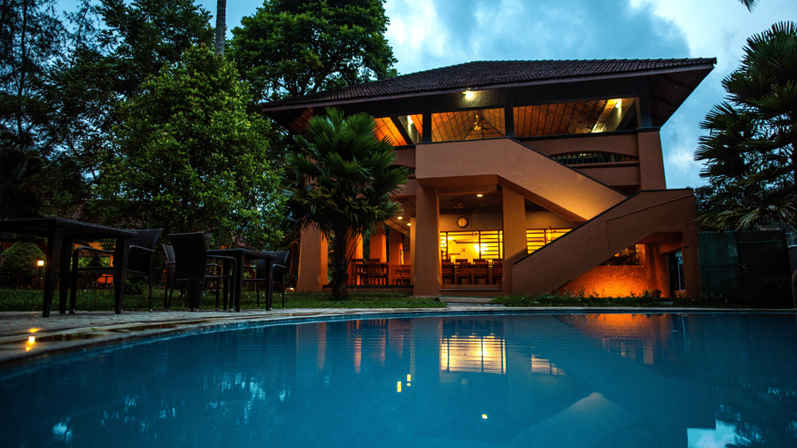 A serene poolside view surrounded by greenery at one of the finest resorts in Thekkady, offering a tranquil retreat at Abad Green Forest, Thekkady.