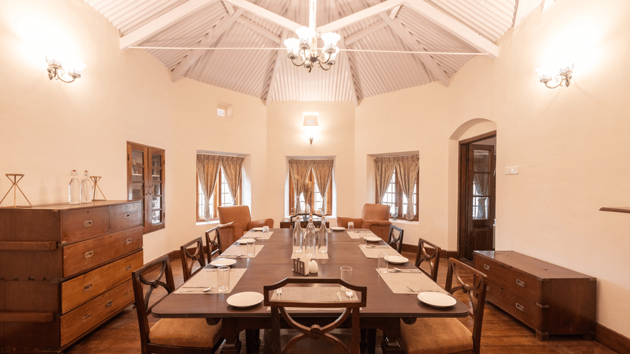 The interiors of the dining hall with a long dining table and rounded walls - Ibex Resort, Coonoor (Leewood).
