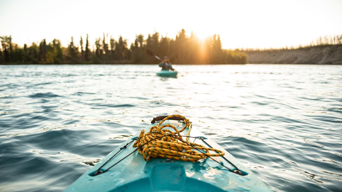 people boating on a lake in evening time