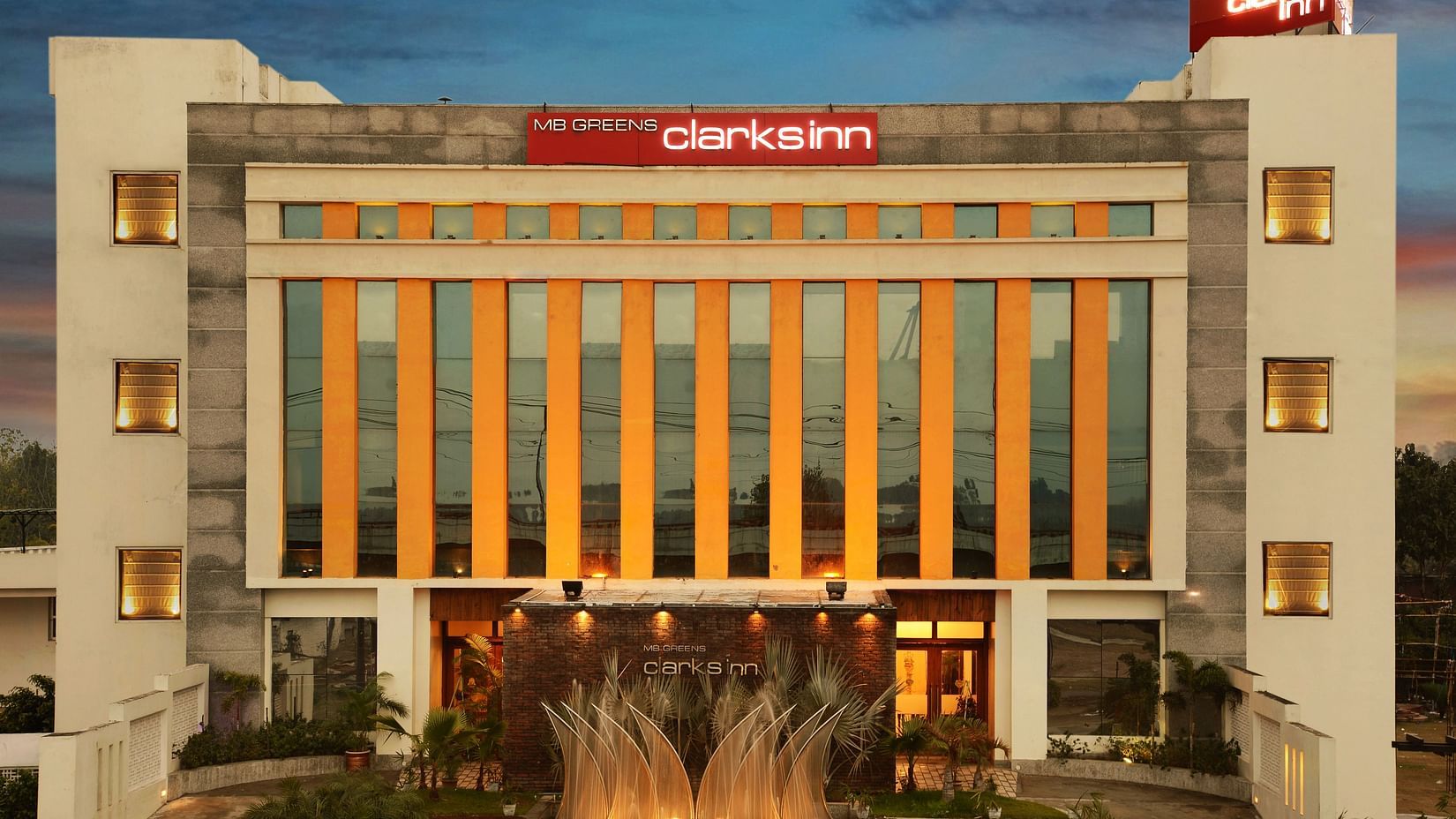 Facade of MB Greens Clarks Inn, Moradabad under evening sky