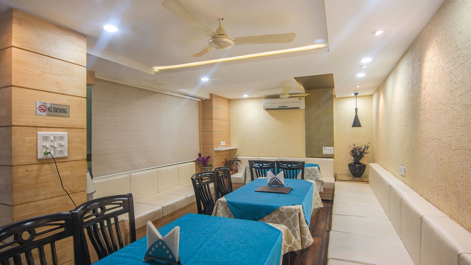 A restaurant with several tables and chairs - Hotel Morya, Bhopal