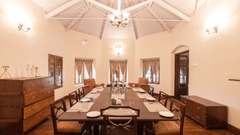 The interiors of the dining hall with a long dining table and rounded walls - Ibex Resort, Coonoor (Leewood).