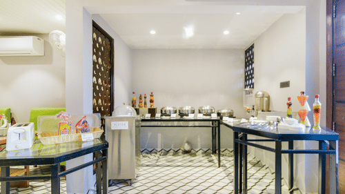 A bright and elegant buffet area at Hotel Bluestone Prime (Nehru Place), New Delhi featuring neatly arranged dishes, stylish decor, and a welcoming dining atmosphere.