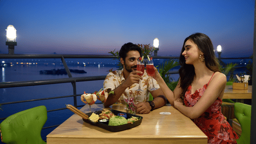 a couple enjoying food at the outdoor dining space 3 - polo floatel kolkata