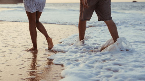 couple walking on the beach at our honeymoon resort in Goa