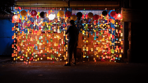 A decorative display with colorful patterns and lights at a shop structure.