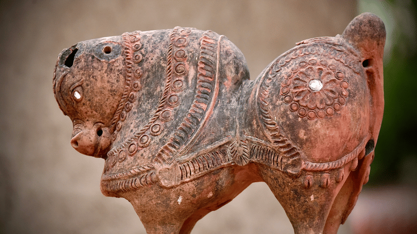 A close up shot of a small horse sculpture made of clay.