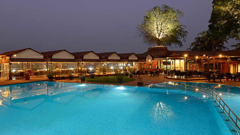 An exterior view of  The Dukes retreat, khandala during night time featuring the swimming pool