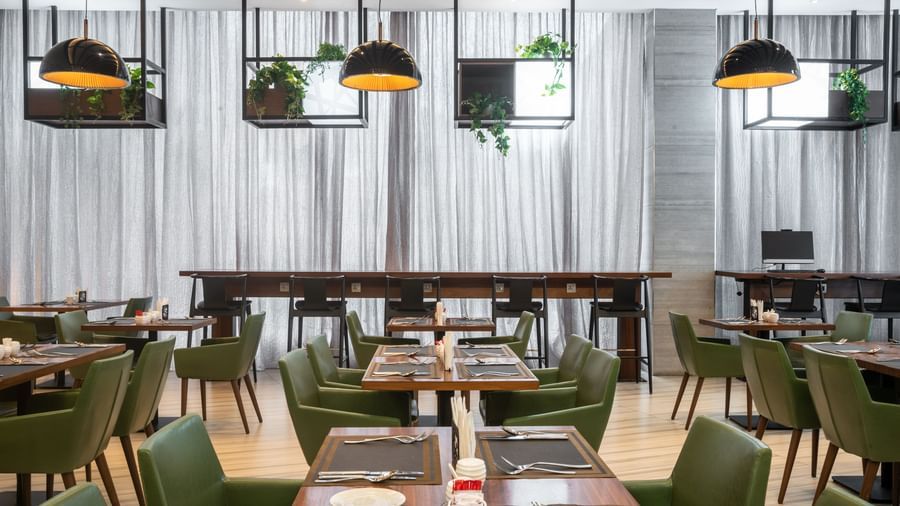 Restaurant seating at Best Western Premier Westlands set with plates and cutlery.
