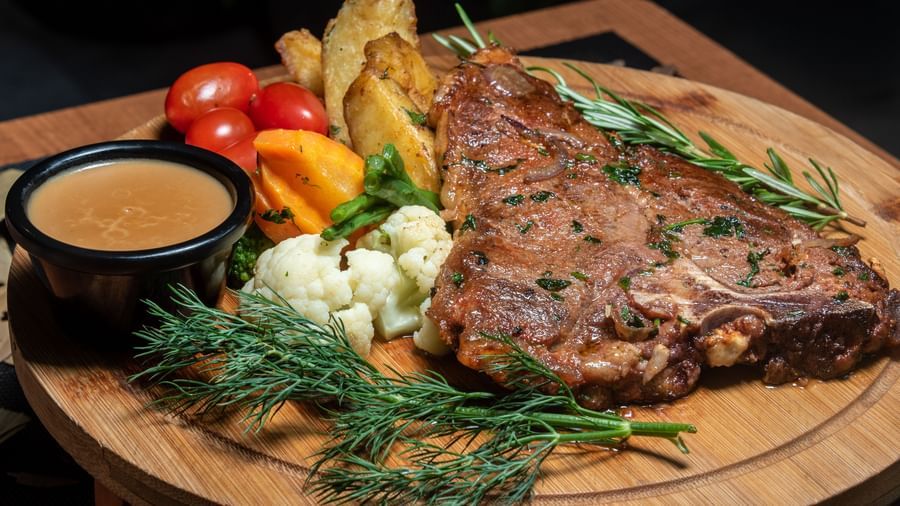 Juicy grilled steak served with vegetables, fries, and sauce at Best Western Premier Westlands hotel steakhouse restaurant.