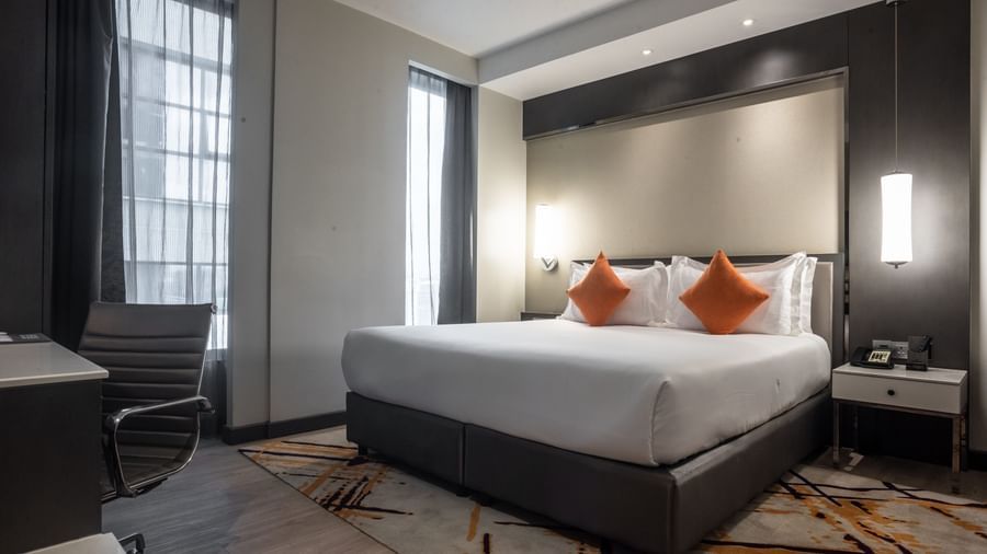 A corner angle of a room with a large bed and bed lights at Best Western Premier Westlands.