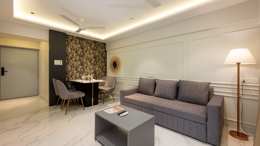 Spacious living room with sofa and seating area at Home2 Residency, Mumbai Airport
